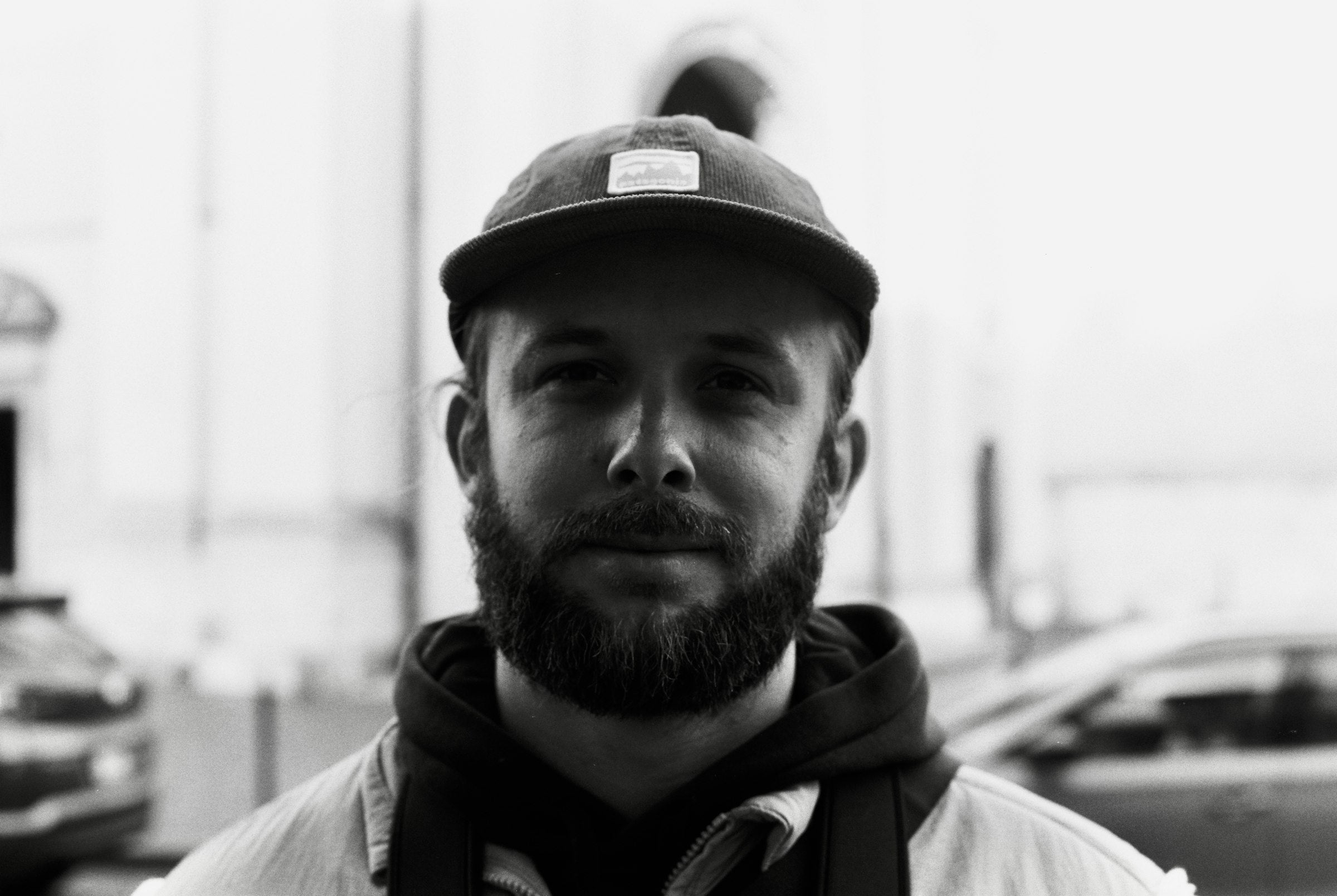 Man wearing a premium baseball cap outdoors, candid editorial lifestyle photo